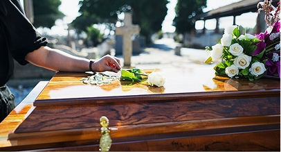 woman resting hand on coffin