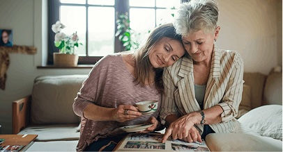 mother and daughter looking at photo album