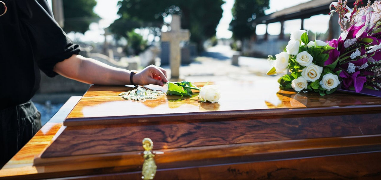 a woman touching a coffin