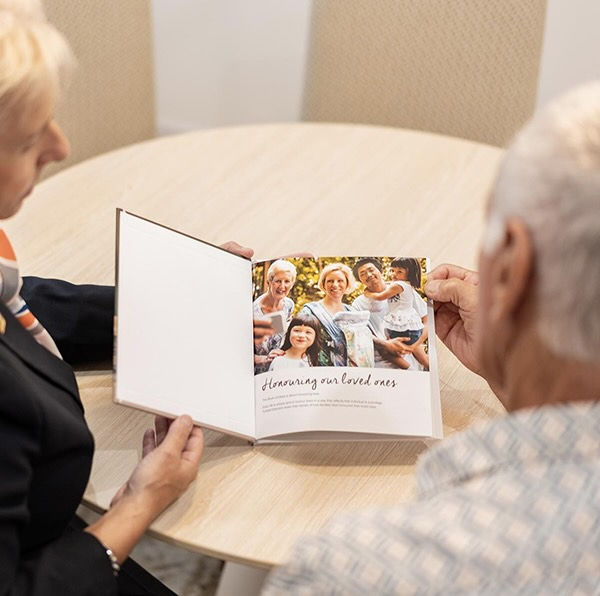 funeral director showing a man a album