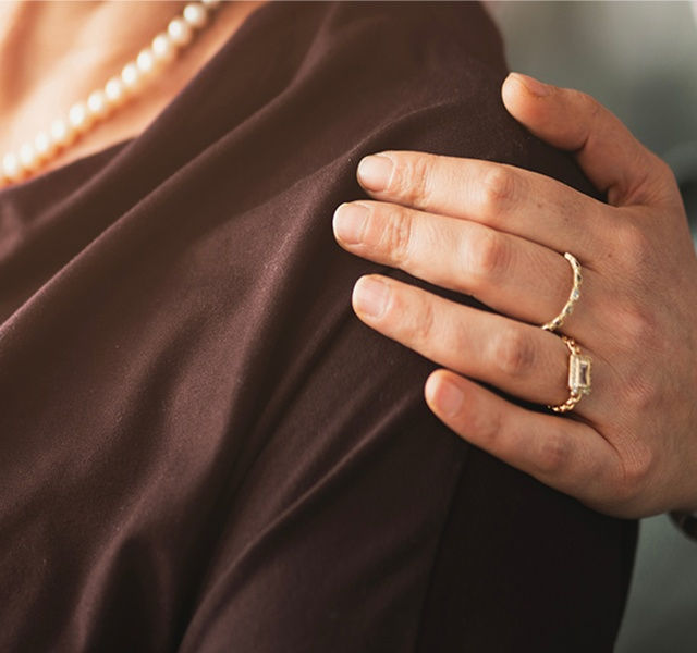 a hand on a person's shoulder