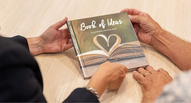 two people holding a book